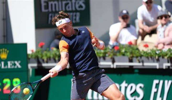 Casper Ruud forehands the ball at the French Open in 2023.
