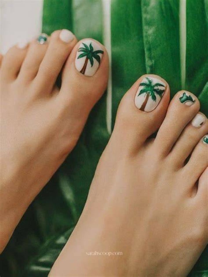 Palm tree toe nail design (L) and cherry nail design (R) are examples of beach summer toe nail designs.
