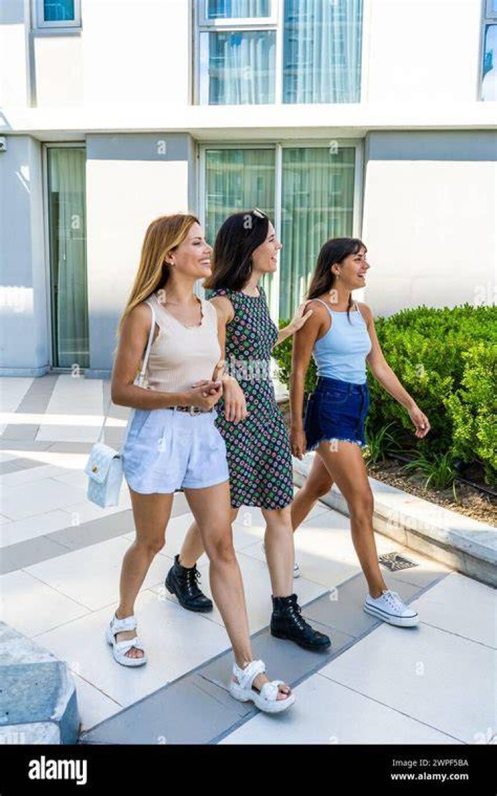 Three models walk down the runway wearing lavender dresses